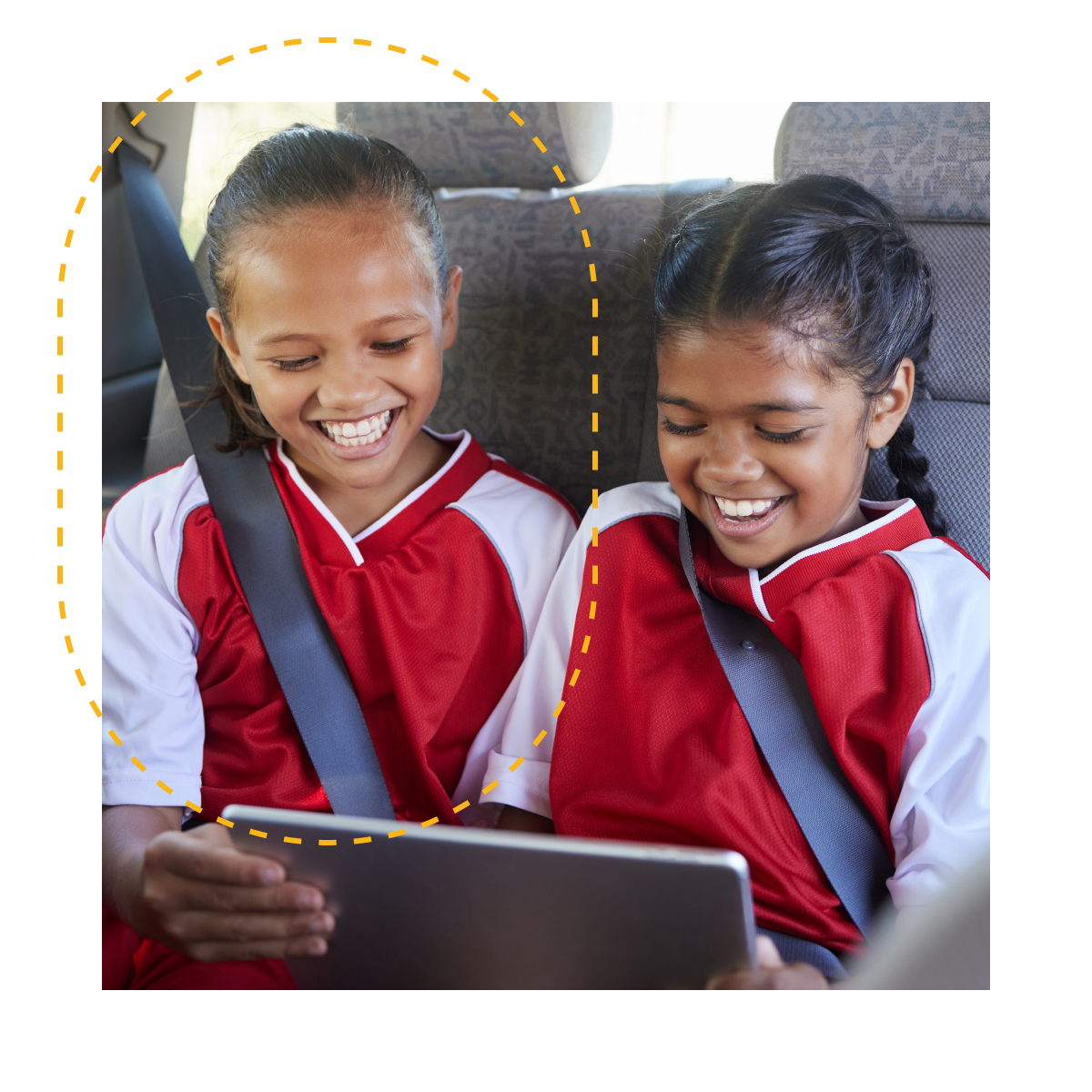 Two youth sports players in a car before their game watching the live stream of another game