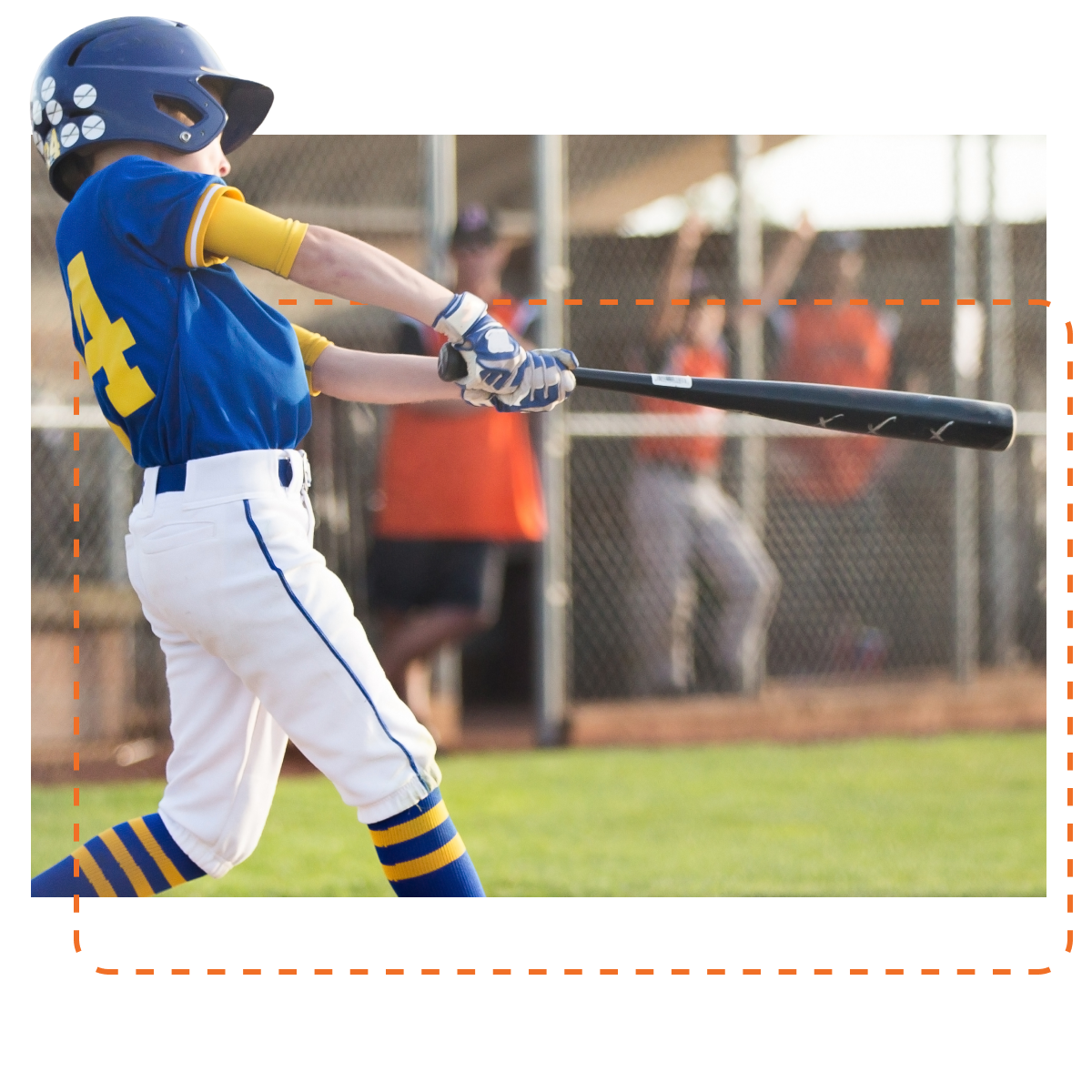 A youth baseball player in a blue and gold uniform is mid-swing after hitting a baseball, with focus on the player and a blurred background of a dugout and spectators, capturing a moment of athletic performance on the field.