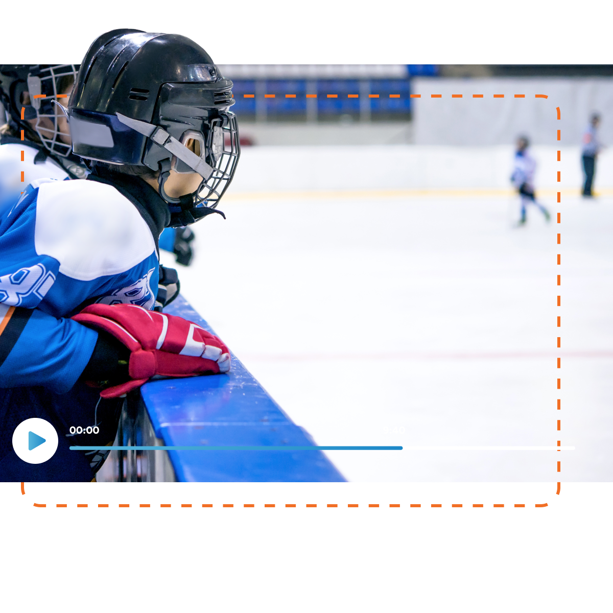A young ice hockey player in a blue jersey leaning over the boards of an ice rink, watching teammates on the ice. A play button and timer at the bottom suggest the image is from a video, possibly for coaching or facility management software analysis.